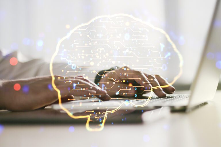 Digitised, AI-powered brain graphic overlaying hands typing on a keyboard to represent bidding with AI